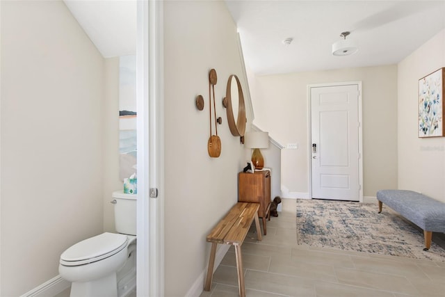 bathroom featuring toilet and tile patterned floors