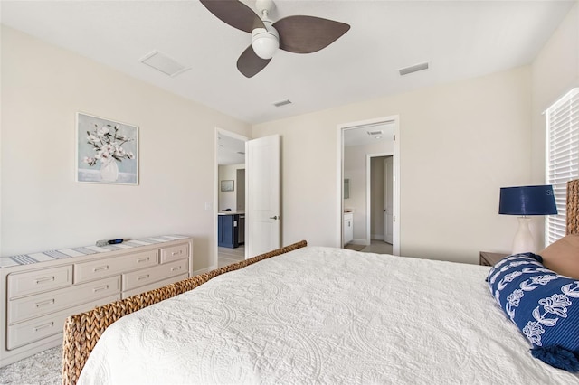 bedroom featuring ceiling fan and connected bathroom