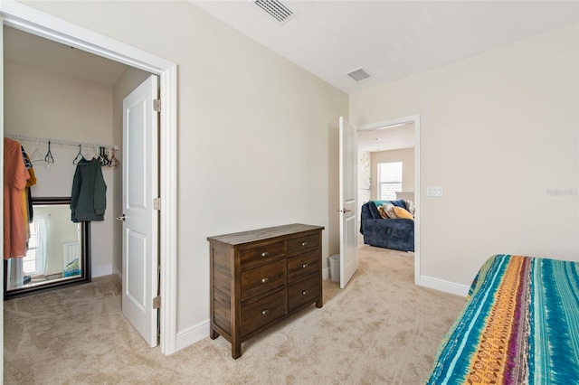 bedroom featuring light carpet