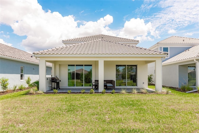 rear view of house with a yard and a patio