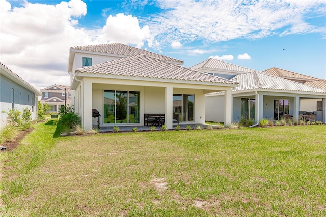 rear view of property with a lawn