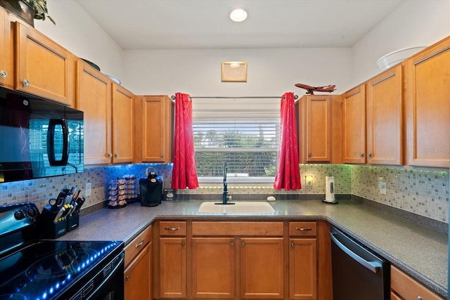 kitchen featuring black appliances, tasteful backsplash, and sink