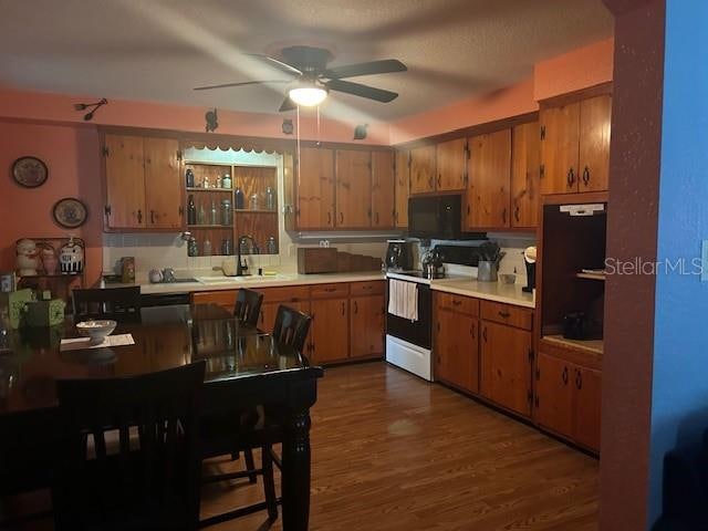 kitchen featuring dark wood-type flooring, sink, ceiling fan, and white electric range oven