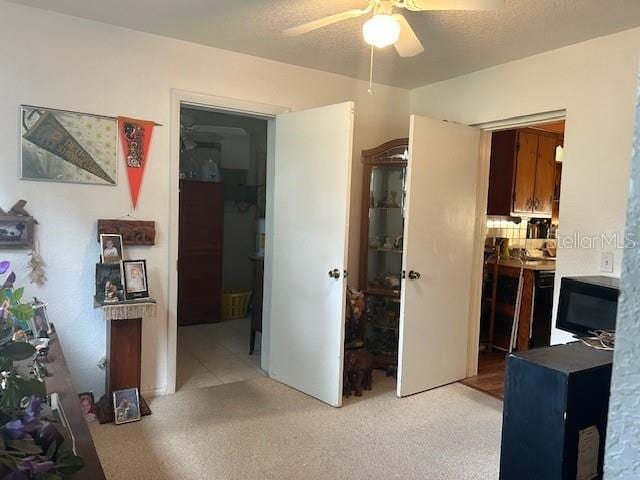 carpeted bedroom featuring a textured ceiling, a spacious closet, ceiling fan, and a closet