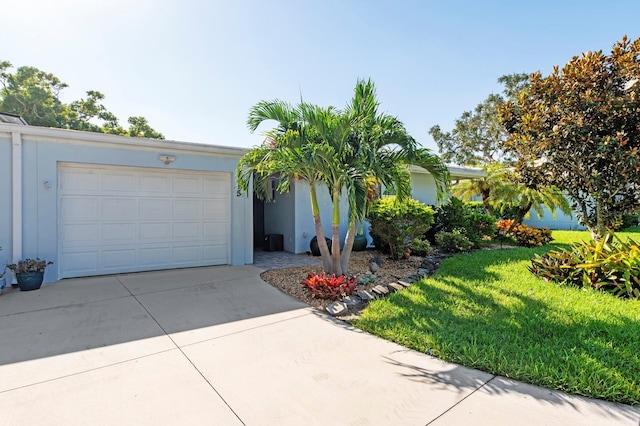 ranch-style home with a front lawn and a garage