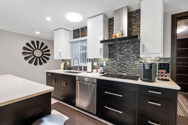 kitchen with dishwasher, backsplash, sink, black electric stovetop, and wall chimney range hood