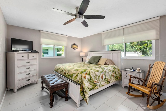 bedroom with multiple windows and ceiling fan