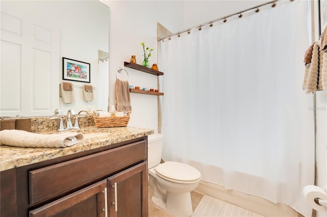 full bathroom featuring shower / tub combo with curtain, tile patterned floors, vanity, and toilet