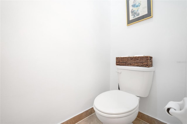 bathroom with tile patterned flooring and toilet