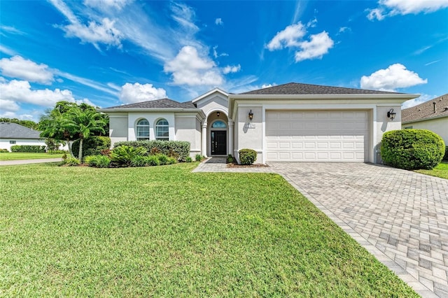 view of front of home featuring a garage and a front lawn