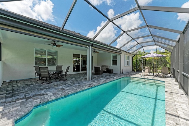 view of swimming pool featuring a lanai, ceiling fan, and a patio