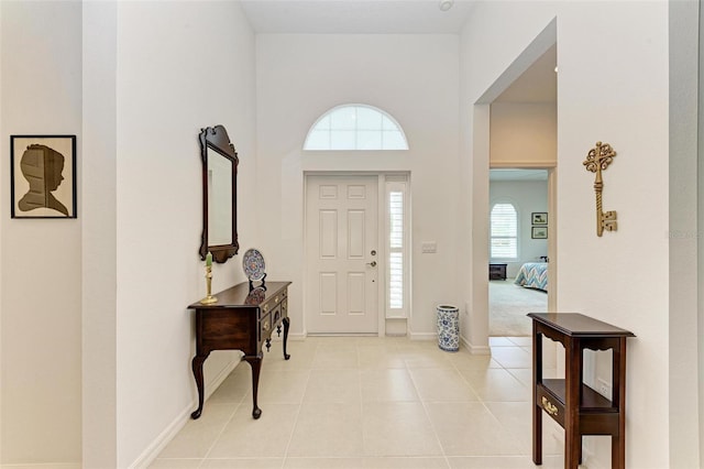 entrance foyer with light tile patterned flooring and baseboards