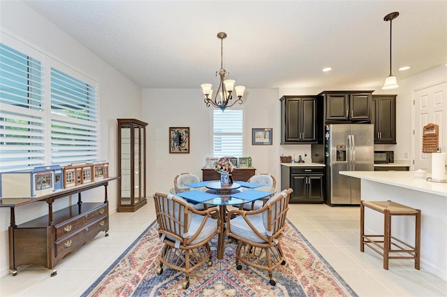 dining space with light tile patterned floors, a notable chandelier, and recessed lighting