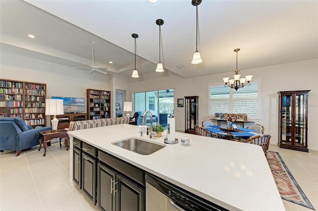 kitchen featuring light tile patterned floors, hanging light fixtures, sink, and ceiling fan with notable chandelier