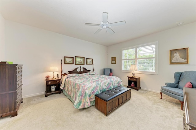bedroom featuring baseboards, a ceiling fan, and light colored carpet