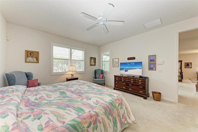 carpeted bedroom with baseboards and ceiling fan
