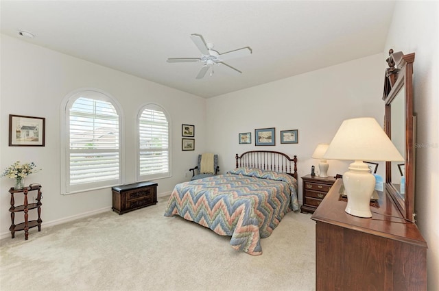 carpeted bedroom featuring baseboards and a ceiling fan