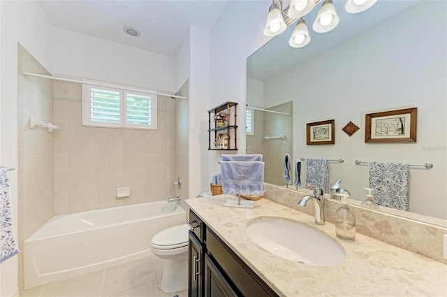 full bathroom featuring tile patterned flooring, tiled shower / bath, toilet, and vanity