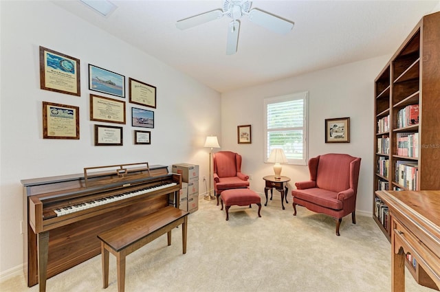 sitting room with ceiling fan and light colored carpet