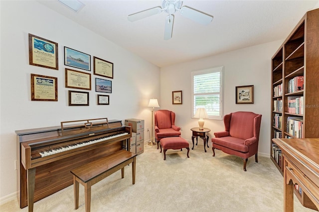 living area featuring light carpet, baseboards, visible vents, and a ceiling fan