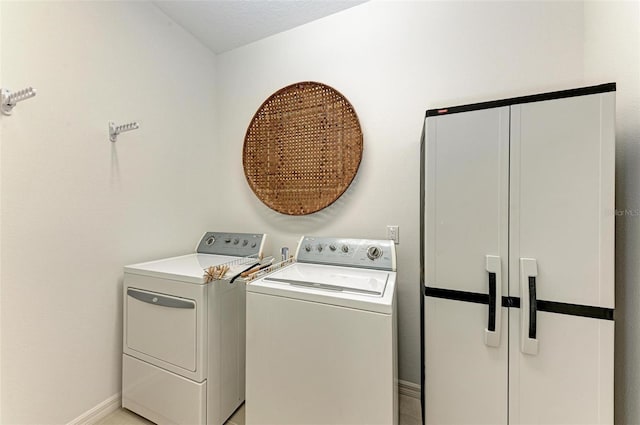 laundry area featuring baseboards, washing machine and clothes dryer, and laundry area