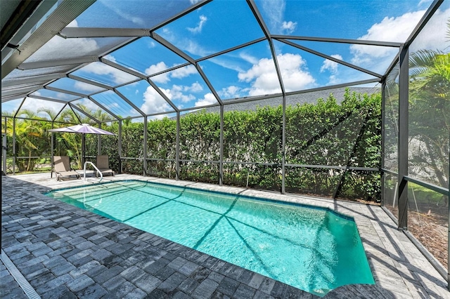 outdoor pool featuring a lanai and a patio area