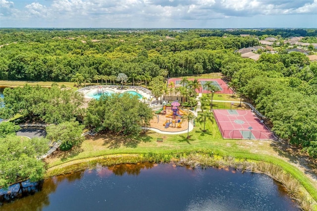 drone / aerial view featuring a water view and a wooded view