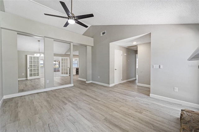 3240 Flamingo Ln, Mulberry, FL 33860 - unfurnished living room featuring vaulted ceiling, a ceiling fan, wood finished floors, and a textured ceiling