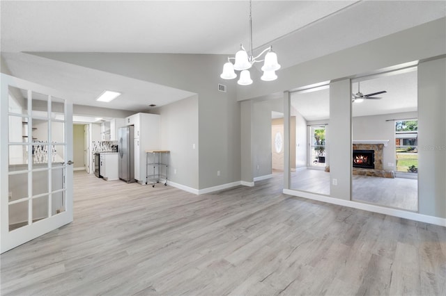 3240 Flamingo Ln, Mulberry, FL 33860 - unfurnished living room featuring light wood-style flooring, a fireplace, a ceiling fan, a chandelier, and high vaulted ceiling