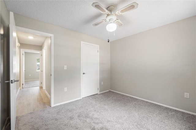 3240 Flamingo Ln, Mulberry, FL 33860 - unfurnished bedroom featuring light carpet, ceiling fan, and a textured ceiling