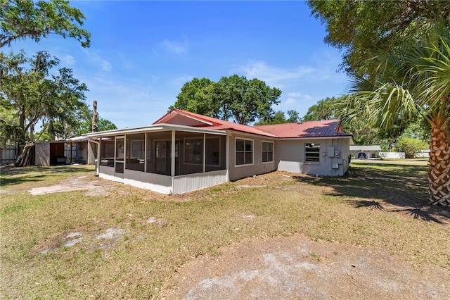 3240 Flamingo Ln, Mulberry, FL 33860 - back of house with a sunroom, a yard, and a metal roof