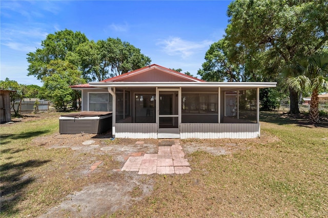3240 Flamingo Ln, Mulberry, FL 33860 - rear view of house featuring a hot tub and a sunroom