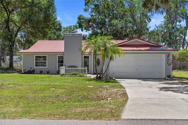 3240 Flamingo Ln, Mulberry, FL 33860 - view of front of home with stucco siding, a garage, driveway, and a metal roof