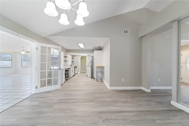 3240 Flamingo Ln, Mulberry, FL 33860 - unfurnished living room featuring vaulted ceiling, a chandelier, light wood-type flooring, and ceiling fan