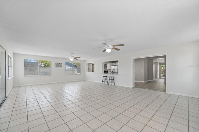 3240 Flamingo Ln, Mulberry, FL 33860 - unfurnished living room with a ceiling fan and light tile patterned flooring