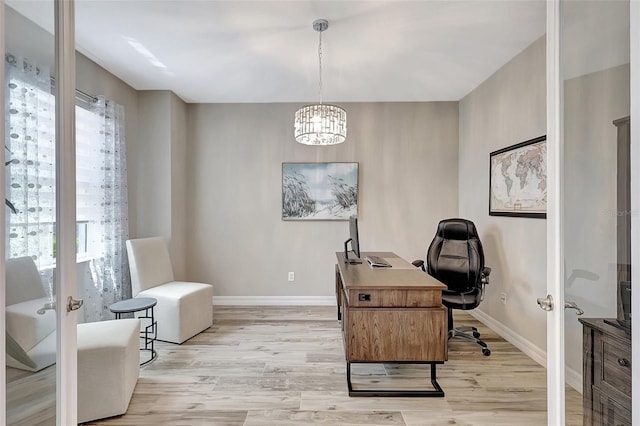 office featuring french doors, a chandelier, and light hardwood / wood-style flooring