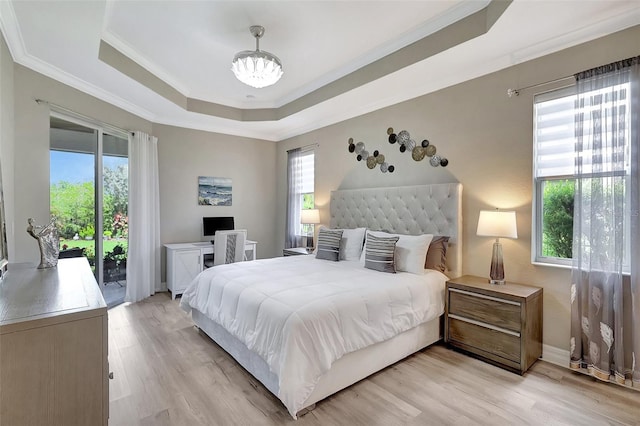 bedroom with a tray ceiling, ornamental molding, access to exterior, and light hardwood / wood-style flooring