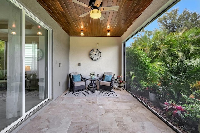 sunroom with wood ceiling and ceiling fan