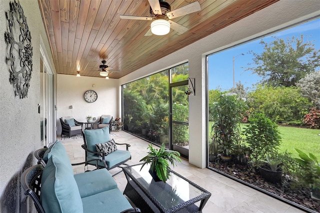 sunroom / solarium with wood ceiling and ceiling fan