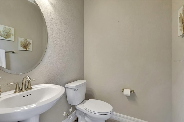 bathroom with toilet and sink