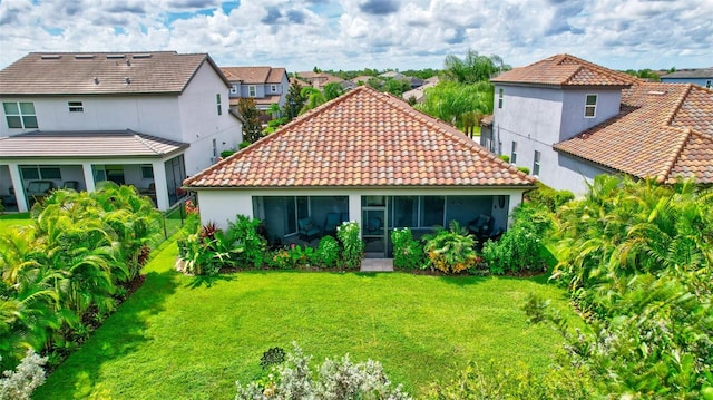 rear view of house with a yard