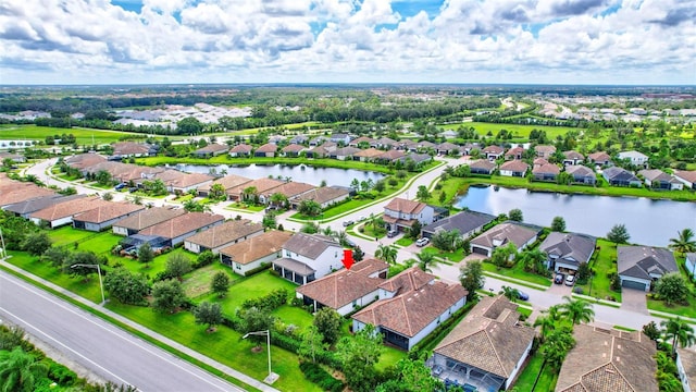 birds eye view of property with a water view