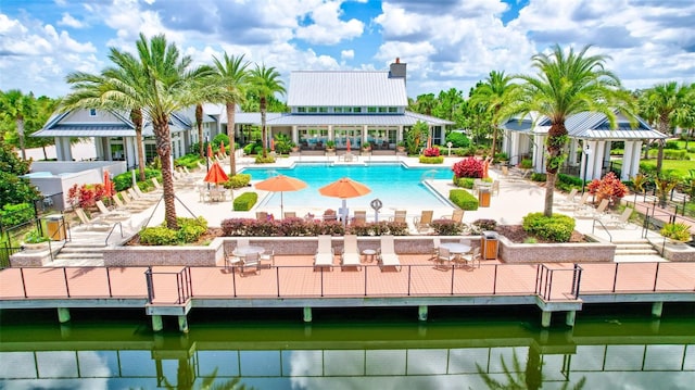 view of pool with a patio area and a water view