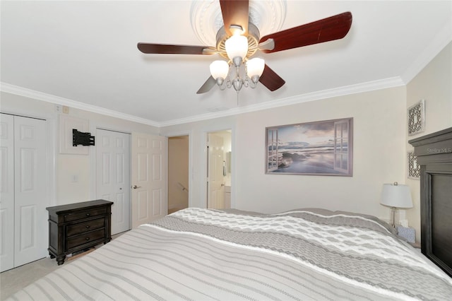 bedroom with crown molding, connected bathroom, two closets, and ceiling fan