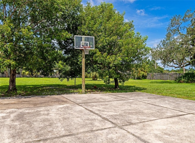 view of basketball court featuring a yard