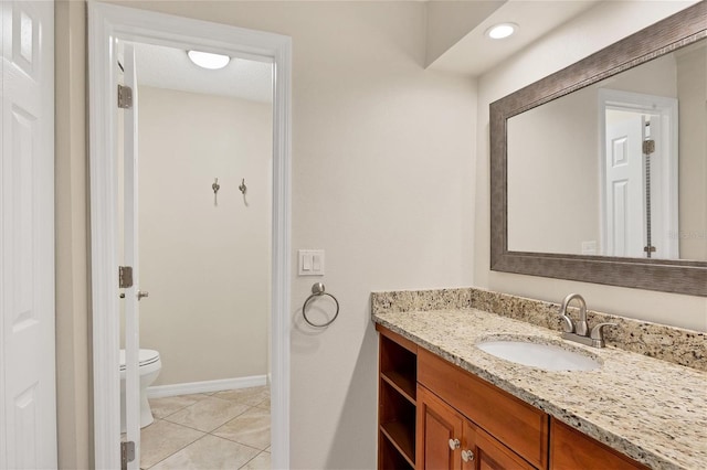 bathroom featuring tile patterned flooring, vanity, and toilet