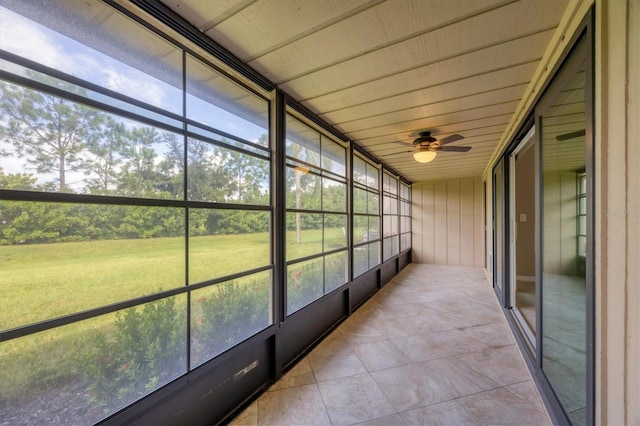 unfurnished sunroom featuring ceiling fan