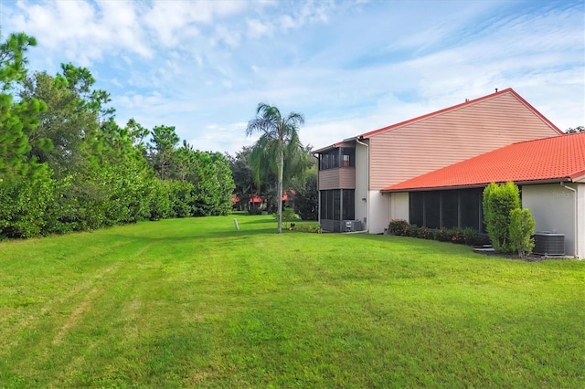 6384 Draw Ln Unit 38, Sarasota, FL 34238 - view of grassy yard featuring a sunroom and cooling unit