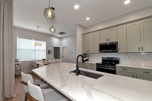 kitchen featuring gray cabinetry, light hardwood / wood-style floors, sink, electric range oven, and tasteful backsplash