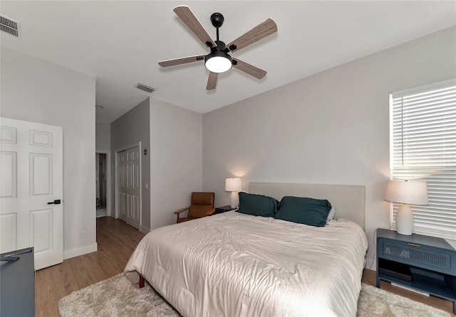 bedroom with light wood-type flooring and ceiling fan